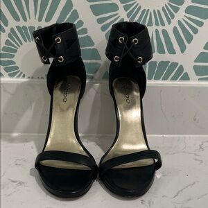 bebe Black Open-Toe Ankle-Strap Heels with Gold Accent